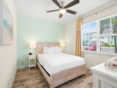 a white bedroom with a bed and a window at Breezy Blue Villa Near Disney With Margaritaville Resort And Island H20 Waterpark Access - 2902Cl in Orlando
