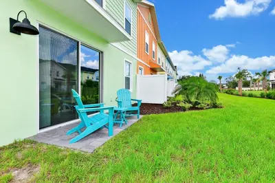two blue chairs and a table outside of a house at Lime Green Villa Near Disney With Margaritaville Resort & Island H20 Waterpark Access - 2930Cl in Orlando