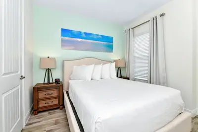 a bedroom with a white bed and a window at Lime Green Villa Near Disney With Margaritaville Resort & Island H20 Waterpark Access - 2930Cl in Orlando