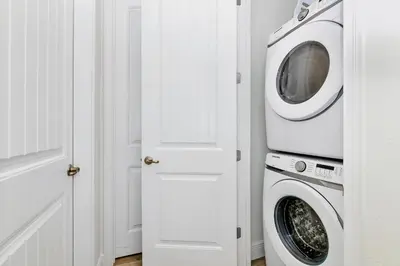 a washer and dryer in a white laundry room at Lime Green Villa Near Disney With Margaritaville Resort & Island H20 Waterpark Access - 2930Cl in Orlando
