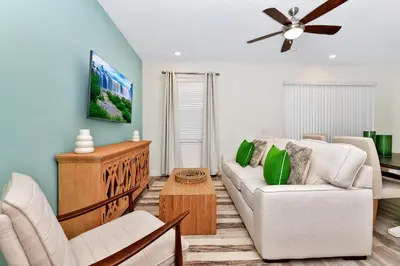 a living room with a couch and a ceiling fan at Lime Green Villa Near Disney With Margaritaville Resort & Island H20 Waterpark Access - 2930Cl in Orlando