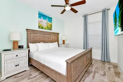 a bedroom with a bed and a ceiling fan at Sea Blue Villa Near Disney With Margaritaville Resort & Island H20 Access - 3164Cs in Orlando