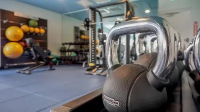 a gym with several rows of machines at Sunshine Cottage With Private Pool Near Disney With Margaritaville Resort & Island H20 Access - 8165Su in Orlando