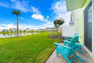 a blue chair sitting on the side of a house at Lime Green Villa Near Disney With Margaritaville Resort & Island H20 Waterpark Access - 2965Cs in Orlando