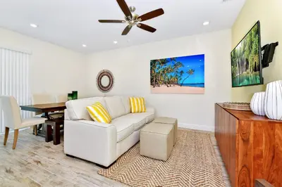 a living room with a white couch and a table at Lovely Villa Near Disney With Margaritaville Resort & Island H20 Waterpark Access - 2947Cl in Orlando