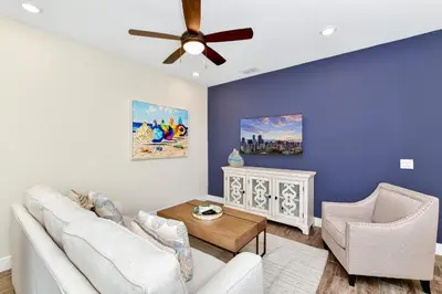 a living room with a white couch and a ceiling fan at Palm Tree Paradise Villa Near Disney With Margaritaville Resort & Island H20 Waterpark Access - 3113Cs in Orlando