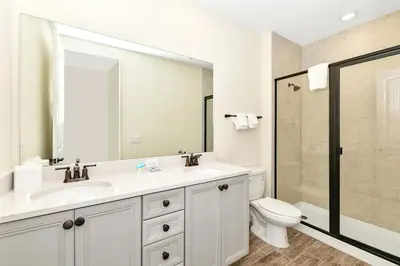 a bathroom with a sink and a toilet and a shower at Palm Tree Paradise Villa Near Disney With Margaritaville Resort & Island H20 Waterpark Access - 3113Cs in Orlando