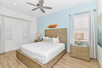 a bedroom with a bed and two windows at Paradise Cottage With Private Pool Near Disney With Margaritaville Resort & Island H2O Access - 8085Su in Orlando