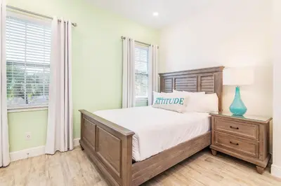 a bedroom with a large bed and a window at Tropical Paradise Cottage Near Disney With Private Hot Tub & Margaritaville Resort & Island H20 Waterpark Access - 2987La in Orlando