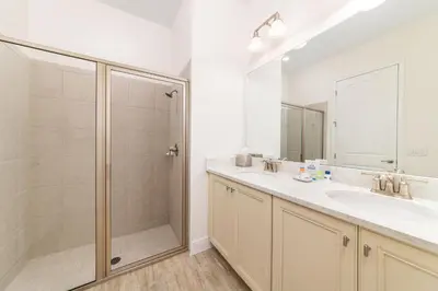 a bathroom with a shower and a sink and a mirror at Tropical Paradise Cottage Near Disney With Private Hot Tub & Margaritaville Resort & Island H20 Waterpark Access - 2987La in Orlando
