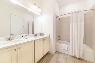 a bathroom with a sink and a tub and a shower at Tropical Paradise Cottage Near Disney With Private Hot Tub & Margaritaville Resort & Island H20 Waterpark Access - 2987La in Orlando