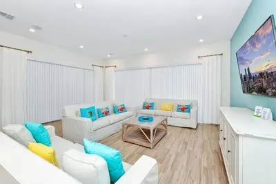 a living room with two white couches and a table at The Shark Tank Cottage With Private Pool Near Disney & Margaritaville Resort & Island H20 Waterpark Access - 3084Ph in Orlando