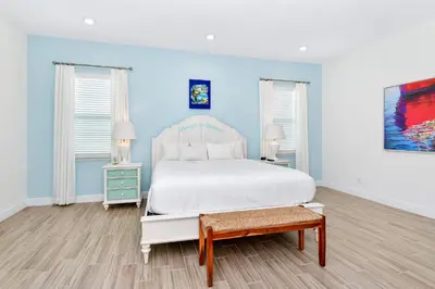 a bedroom with a white bed and blue walls at The Shark Tank Cottage With Private Pool Near Disney & Margaritaville Resort & Island H20 Waterpark Access - 3084Ph in Orlando