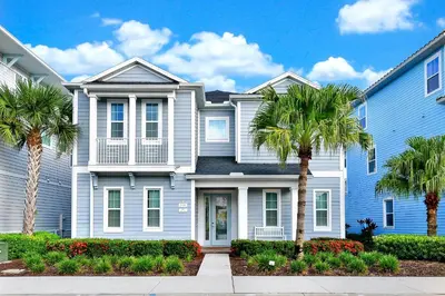 a blue house with palm trees in front of it at The Shark Tank Cottage With Private Pool Near Disney & Margaritaville Resort & Island H20 Waterpark Access - 3084Ph in Orlando