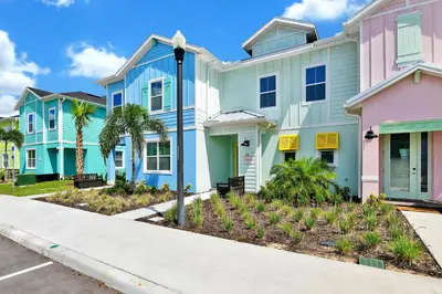 a row of colorful houses with a street light at Serene Villa Near Disney With Margaritaville Resort Island H20 Access - 8167Cp in Orlando