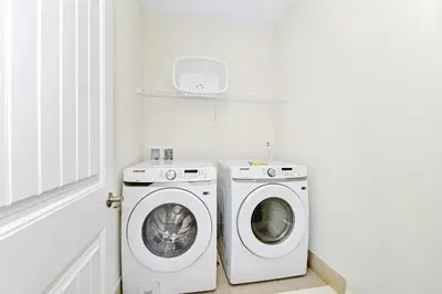 a white laundry room with a washer and dryer at Colorful Villa Near Disney With Margaritaville Resort & Island H20 Waterpark Access- 2919Cl in Orlando
