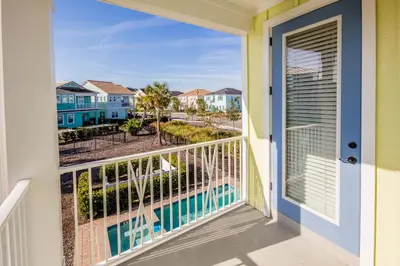 a balcony with a view of a pool and condos at Flip Flops And Tank Tops Cottage With Private Pool Near Disney With Margaritaville Resort & Island H2O Access - 8098Kd in Orlando