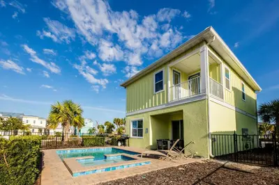 a house with a swimming pool in front of it at Flip Flops And Tank Tops Cottage With Private Pool Near Disney With Margaritaville Resort & Island H2O Access - 8098Kd in Orlando