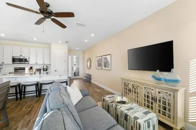 a living room with a couch and a flat screen tv at Cozy Villa Near Disney With Margaritaville Resort & Island H20 Waterpark Access - 3009Cs in Orlando