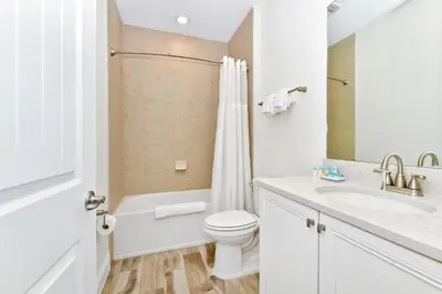 a white bathroom with a toilet and a sink at Colorful Villa Near Disney With Margaritaville Resort & Island H20 Waterpark Access - 3128Cs in Orlando
