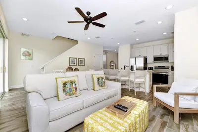 a living room with a white couch and a ceiling fan at Citrus Sunshine Villa Near Disney With Margaritaville Resort & Island H2O Access - 3049Cs in Orlando