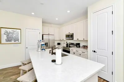 a kitchen with white cabinets and a white counter top at Orange Oasis Villa Near Disney With Margaritaville Resort & Island H20 Waterpark Access - 3097Cs in Orlando