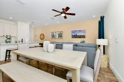 a dining room and kitchen with a table and a ceiling fan at Colorful Villa Near Disney With Margaritaville Resort & Island H20 Access - 8195Cp in Kissimmee