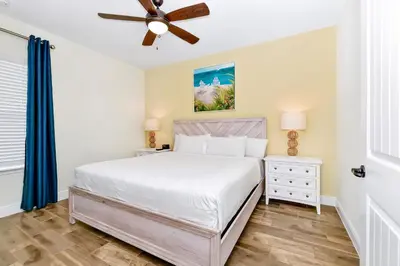 a bedroom with a bed and a ceiling fan at Colorful Villa Near Disney With Margaritaville Resort & Island H20 Access - 8195Cp in Kissimmee