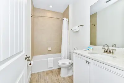 a white bathroom with a toilet and a sink at Lime Green Villa Near Disney With Margaritaville Resort & Island H20 Waterpark Access - 2972Or in Orlando