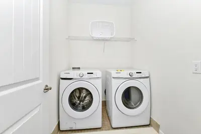 a laundry room with a washing machine and a washer at Pink Villa Near Disney With Margaritaville Resort & Island H20 Access - 8163Cp in Orlando