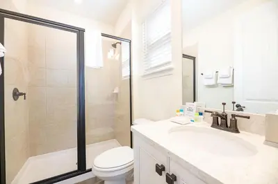 a bathroom with a toilet and a sink and a shower at Sunkissed Cottage With Private Pool Near Disney With Margaritaville Resort & Island H2O Access - 8024Kd in Orlando