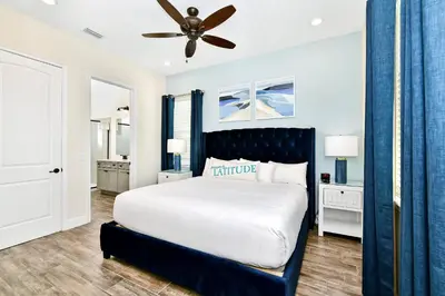 a bedroom with a large bed and a ceiling fan at Sunny Cottage With Private Pool Near Disney With Margaritaville Resort & Island H2O Access - 8021Kd in Orlando