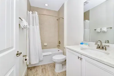 a white bathroom with a toilet and a sink at Bright Villa Near Disney With Margaritaville Resort & Island H20 Access - 8191Cp in Orlando