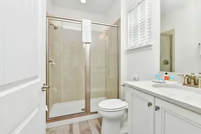 a bathroom with a shower and a toilet and a sink at The Tipsy Turtle Cottage With Private Pool Near Disney With Margaritaville Resort & Island H2O Access - 8012St in Orlando
