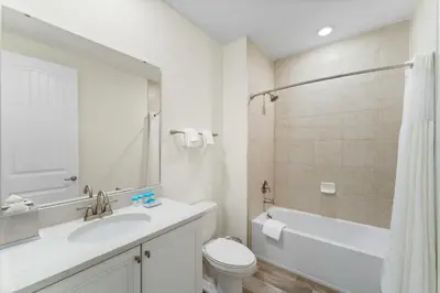 a white bathroom with a sink and a toilet at Bright And Cozy Villa Near Disney With Margaritaville Resort & Island H2O Access - 3053Cs in Orlando