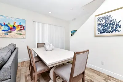 a dining room with a table and chairs and a couch at Lime Green Villa Near Disney With Margaritaville Resort & Island H20 Waterpark Access - 2958Cl in Orlando