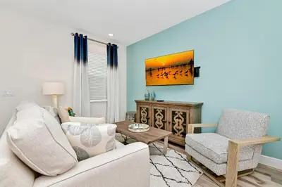 a living room with a couch and a chair at Lovely Villa Near Disney With Margaritaville Resort & Island H20 Waterpark Access - 2956Or in Orlando
