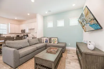a living room with a couch and a table at Cozy Cottage With Private Pool Near Disney With Margaritaville Resort & Island H2O Access - 8041Kd in Orlando