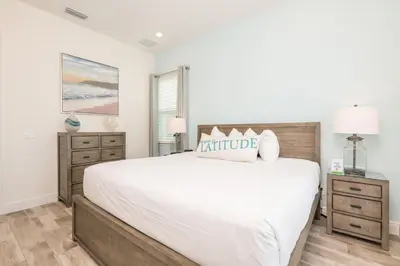 a bedroom with a large white bed and a window at Cozy Cottage With Private Pool Near Disney With Margaritaville Resort & Island H2O Access - 8041Kd in Orlando