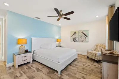 a bedroom with a bed and a ceiling fan at Tropical Villa Near Disney With Margaritaville Resort & Island H20 Waterpark Access - 2945Cs in Orlando
