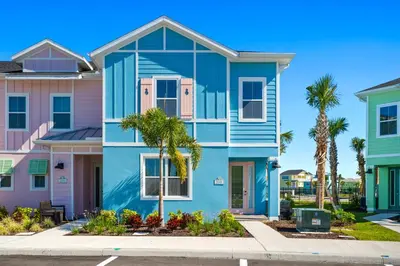 a blue house in a row of houses at Tropical Villa Near Disney With Margaritaville Resort & Island H20 Waterpark Access - 2945Cs in Orlando