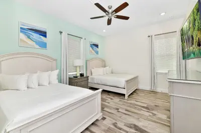 a bedroom with two beds and a ceiling fan at Beautiful Waterfront Cottage With Private Pool Near Disney With Margaritaville Resort & Island H2O Access - 3024Ph in Orlando