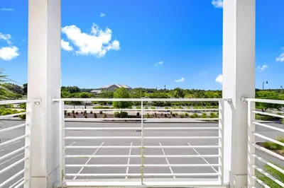 a view from a balcony with a gate at Orange Creamsickle Cottage Near Disney With Margaritaville Resort & Island H20 Waterpark Access - 2980Sr in Orlando