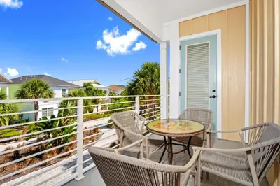 a patio with a table and chairs on a balcony at Orange Creamsickle Cottage Near Disney With Margaritaville Resort & Island H20 Waterpark Access - 2980Sr in Orlando
