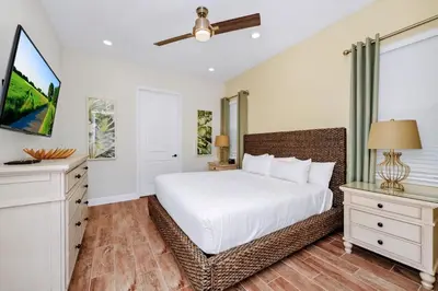 a bedroom with a white bed and a window at Orange Creamsickle Cottage Near Disney With Margaritaville Resort & Island H20 Waterpark Access - 2980Sr in Orlando