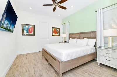 a bedroom with a bed and a ceiling fan at Blue Haven Cottage Near Disney With Margaritaville Resort & Island H20 Waterpark Access - 7996Ls in Orlando