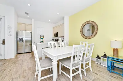 a white dining room with a white table and chairs at Blue Haven Cottage Near Disney With Margaritaville Resort & Island H20 Waterpark Access - 7996Ls in Orlando