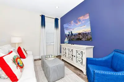 a blue living room with a couch and a chair at Relaxing Villa Near Disney With Margaritaville Resort & Island H20 Waterpark Access - 2992Cs in Orlando