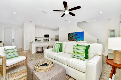 a living room with a white couch and a ceiling fan at Sun Filled Villa Near Disney With Margaritaville Resort & Island H20 Access - 8183Cp in Kissimmee