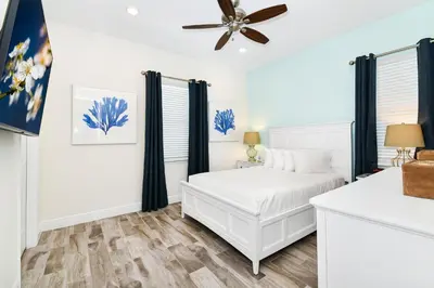a bedroom with a bed and a ceiling fan at Oasis Cottage Near Disney With Margaritaville Resort & Island H20 Waterpark Access - 2936Sr in Orlando